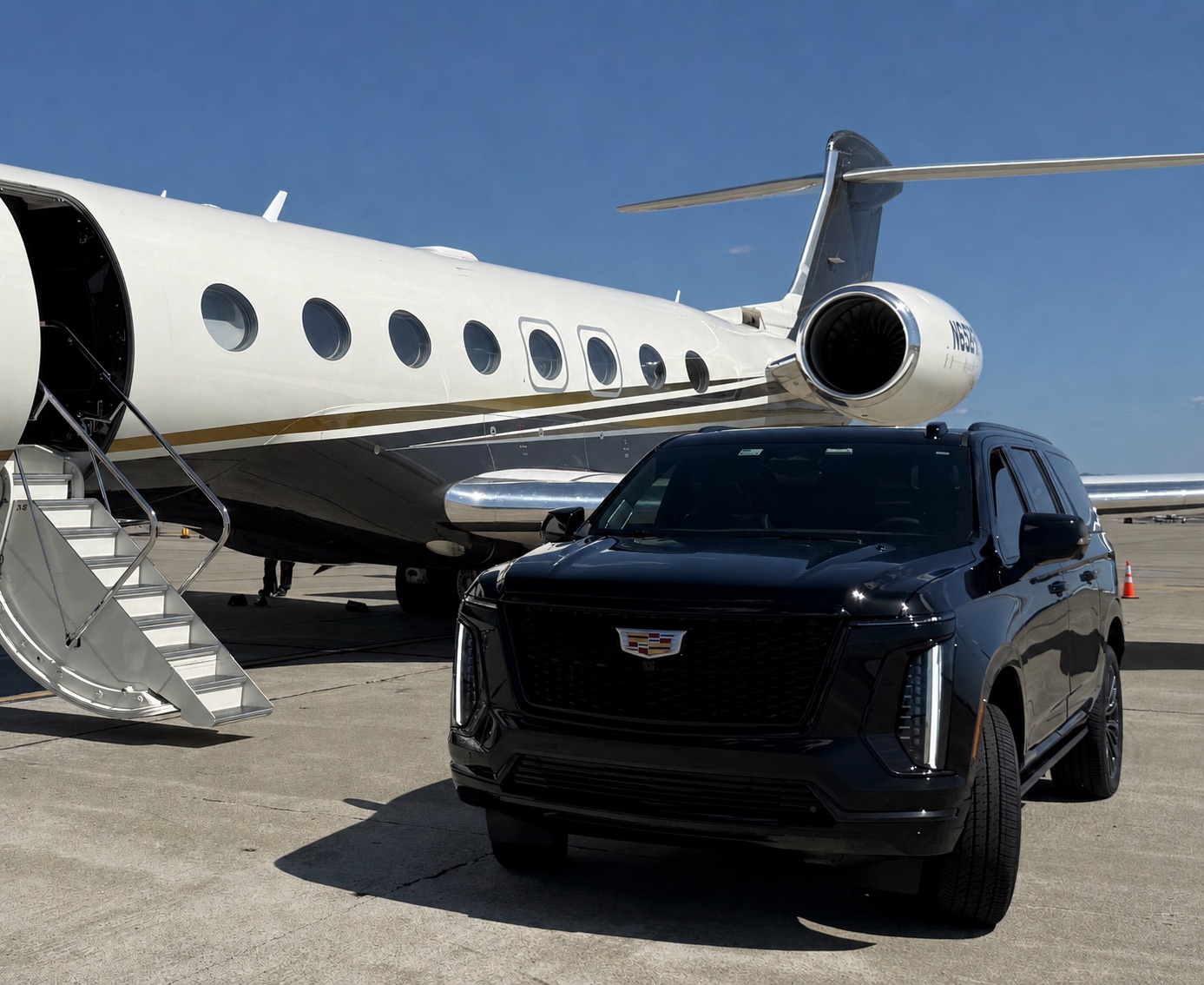 Black Cadillac Escalade beside a Gulfstream private jet