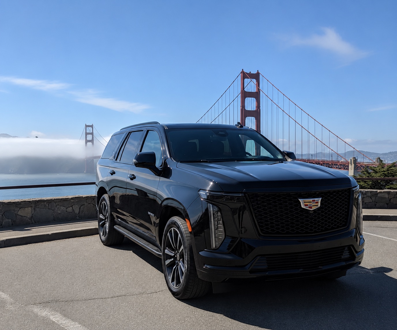 Black Cadillac Escalade in front of the Golden Gate Bridge