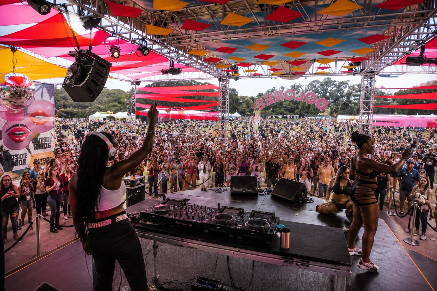 DJ performing to a crowd at an Outside Lands festival stage in Golden Gate Park