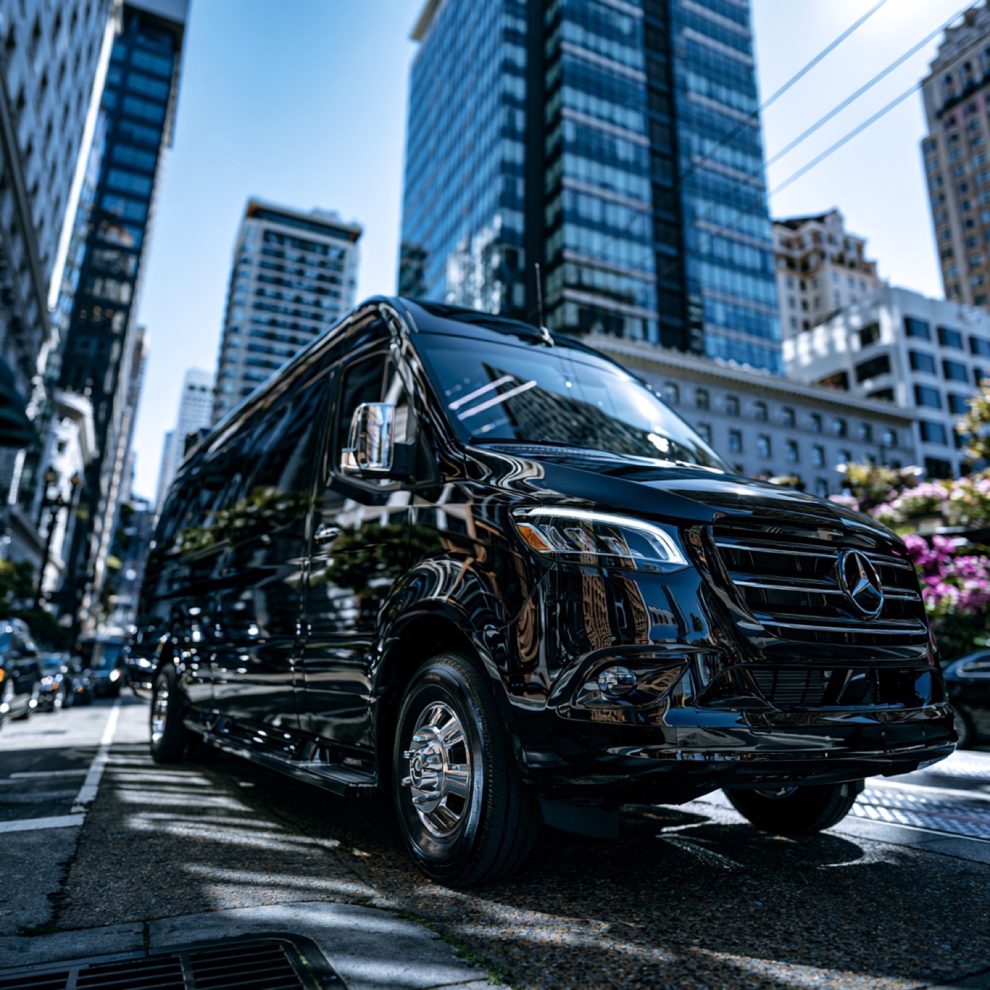 Black Mercedes-Benz Sprinter van on a downtown city street