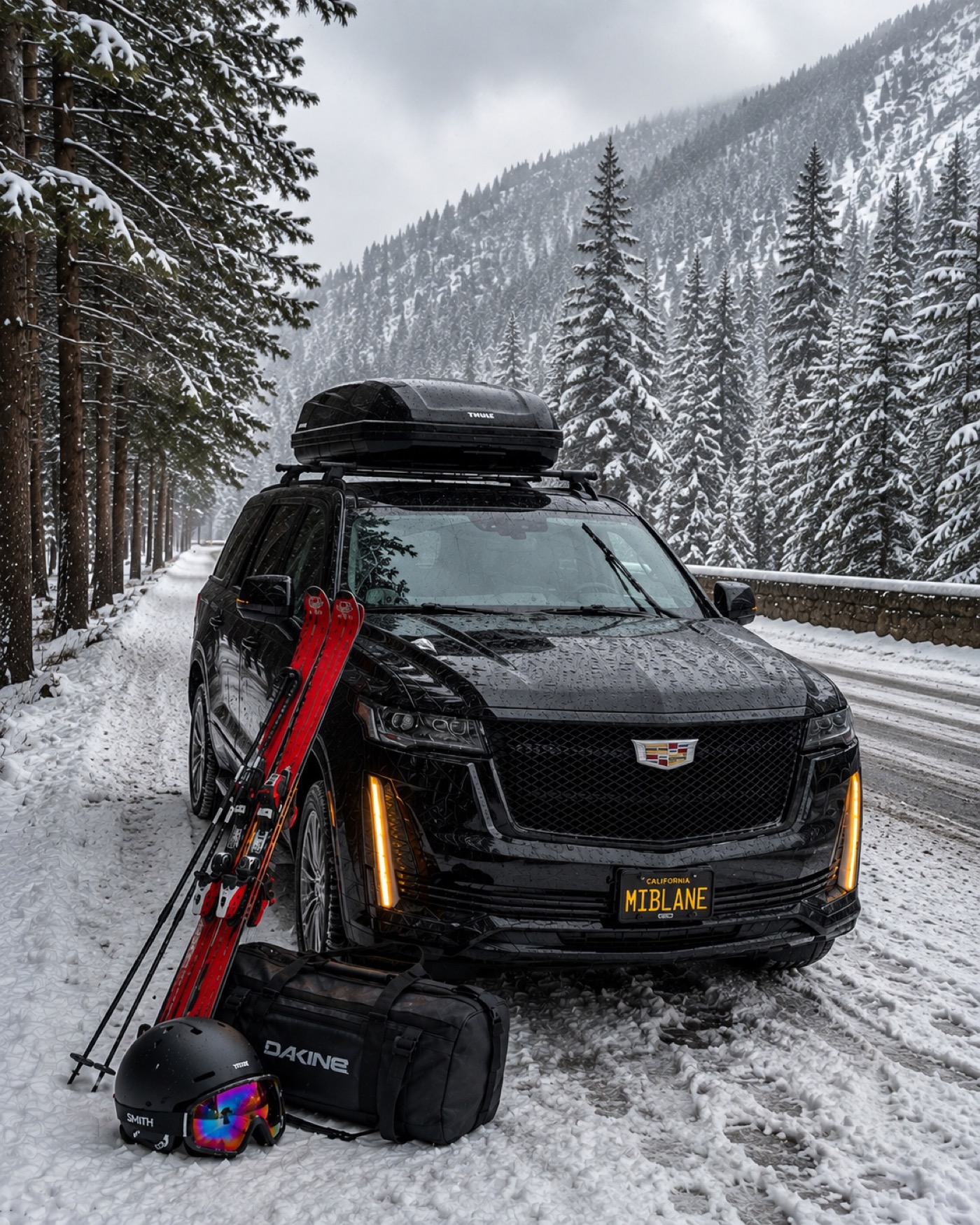 Cadillac Escalade with rear hatch open, loaded with skis and gear in the snow