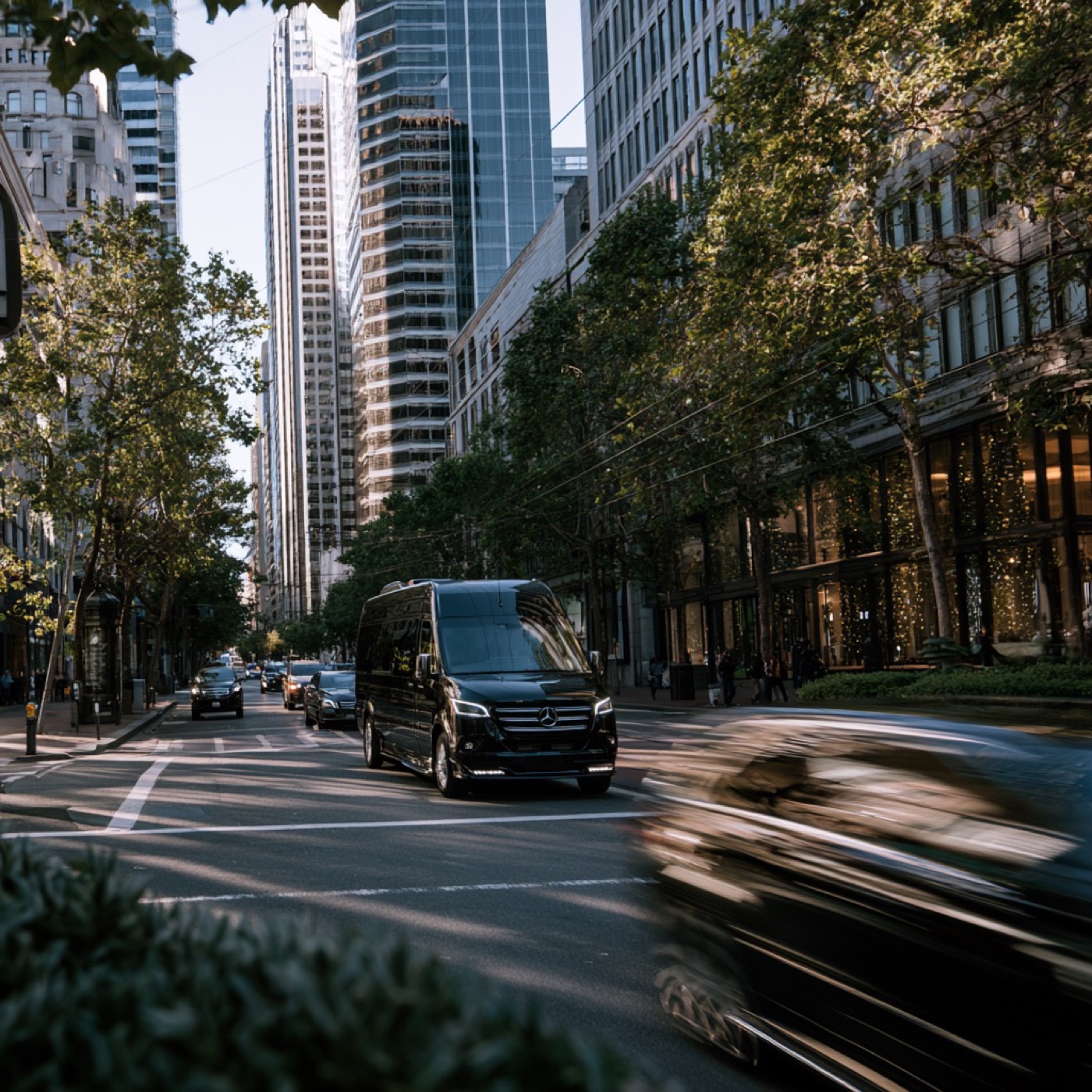 Black Mercedes-Benz Sprinter van moving through downtown San Francisco traffic